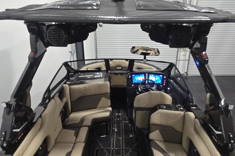 Slide: The Image of Interior of 2026 Centurion R1245 boat with modern dashboard and beige seating. - 9