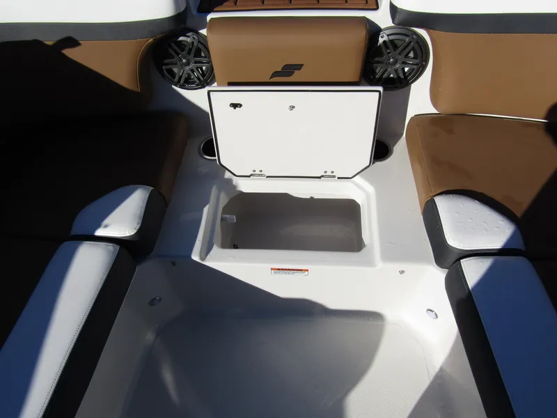 Slide: The Image of 2024 Starcraft SVX 231 OB CC boat interior with seating and storage compartments. - 14