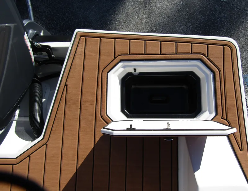 Slide: The Image of 2024 Starcraft SVX 231 OB CC boat deck with brown marine flooring. - 31