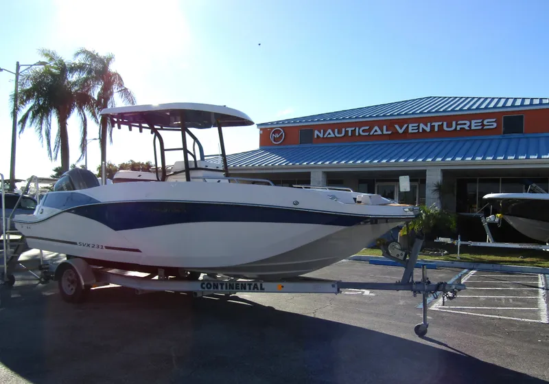 Slide: The Image of 2024 Starcraft SVX 231 OB CC boat interior with brown and white seating. - 8