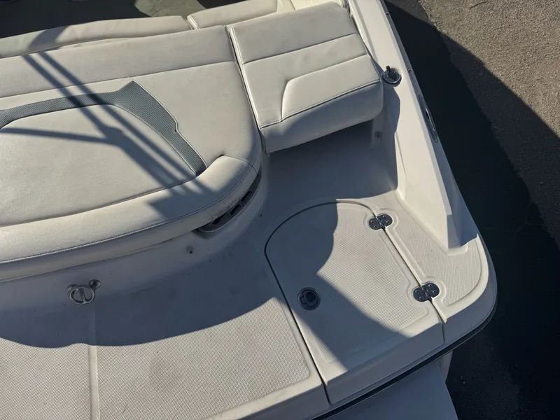 Slide: The Image of 2009 Monterey 194FS boat interior with white seating and storage compartments. - 10