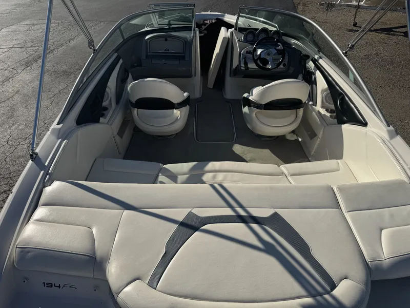 Slide: The Image of 2009 Monterey 194FS boat interior with white seating and steering wheel. - 12