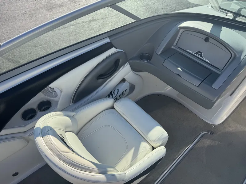 Slide: The Image of 2009 Monterey 194FS boat interior with white seating and dashboard. - 17