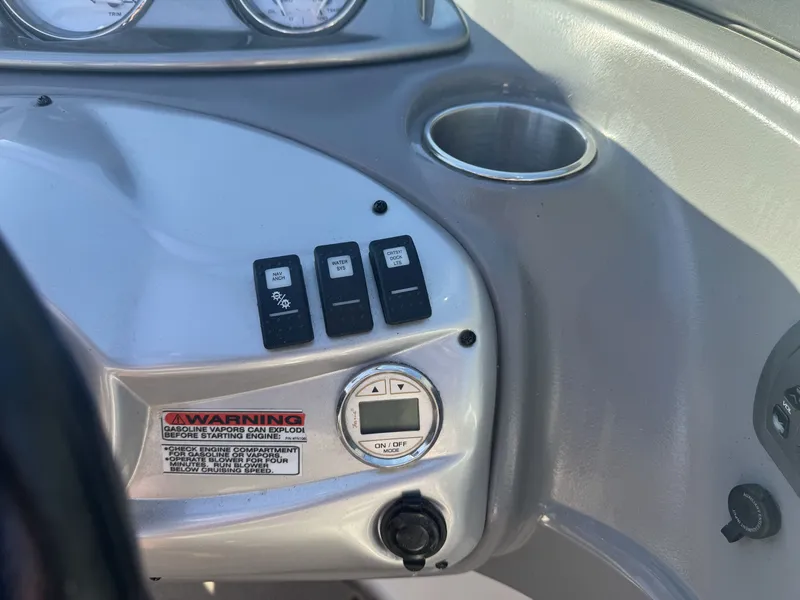 Slide: The Image of Dashboard controls of a 2009 Monterey 194FS boat with warning label and switches. - 22
