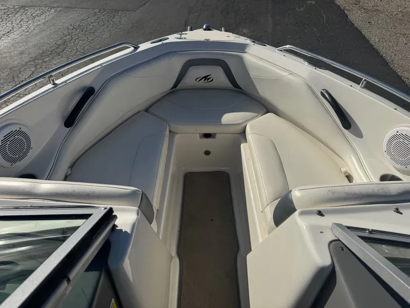 Slide: The Image of 2009 Monterey 194FS boat interior with white seating and speakers. - 23