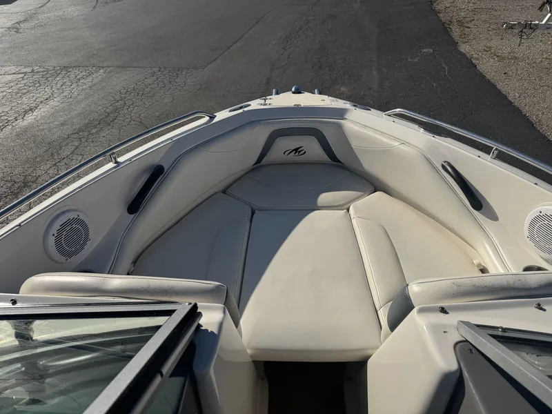 Slide: The Image of 2009 Monterey 194FS boat interior with white seating and speakers. - 24