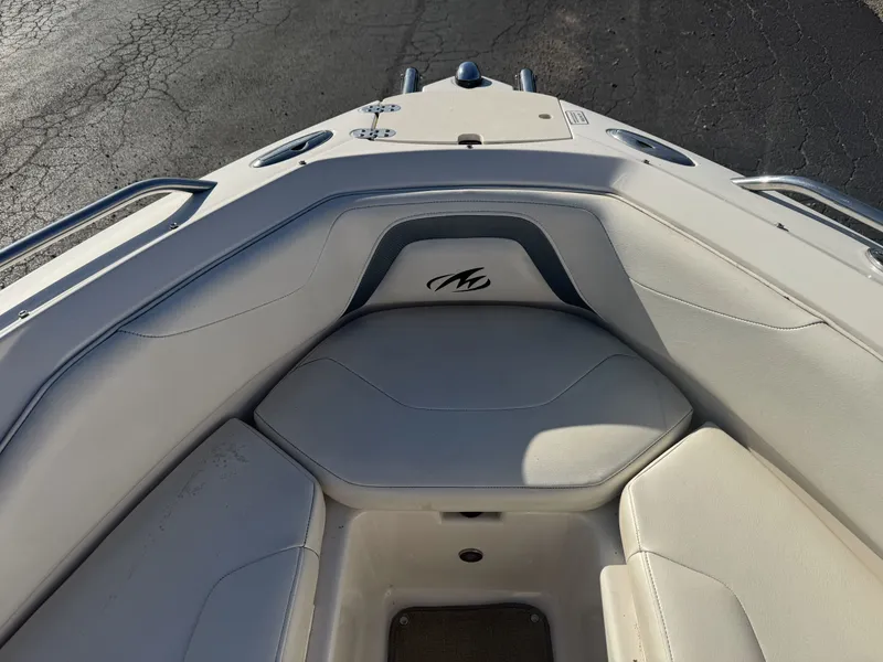 Slide: The Image of Bow seating area of a 2009 Monterey 194FS boat with white upholstery. - 25