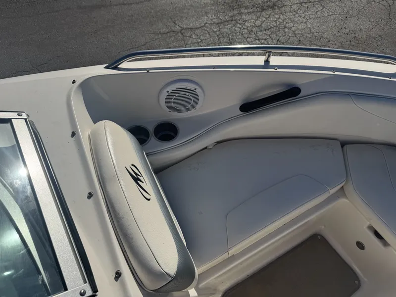 Slide: The Image of 2009 Monterey 194FS boat interior with seating, cup holders, and speaker. - 31