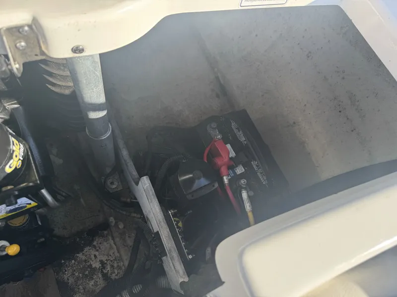 Slide: The Image of 2009 Monterey 194FS boat battery compartment with visible wiring and components. - 33