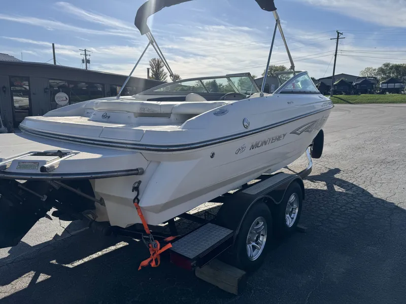 Slide: The Image of 2009 Monterey 194FS boat on trailer in sunny outdoor setting. - 5