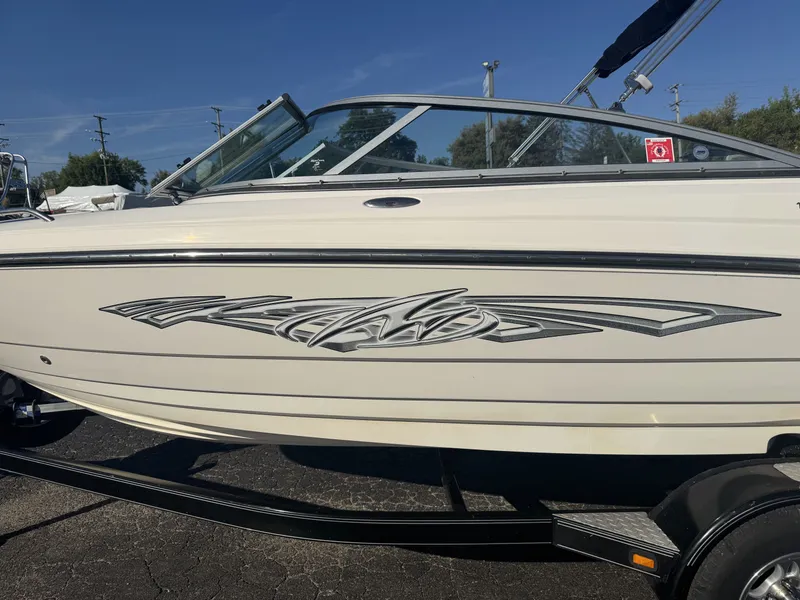 Slide: The Image of 2009 Monterey 194FS boat with sleek design and stylish graphics on trailer. - 7