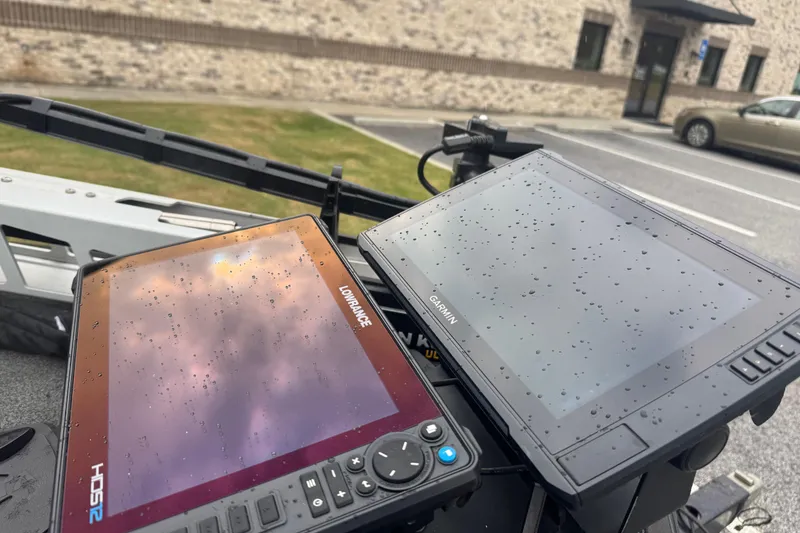 Slide: The Image of Two marine GPS displays, Lowrance and Garmin, on a 2019 Skeeter ZX250 boat, with raindrops. - 5