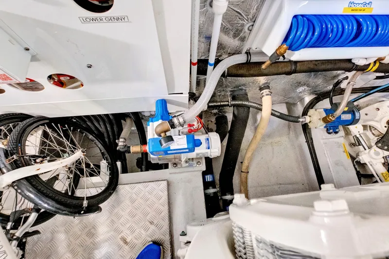 Slide: The Image of Engine room of 2024 Sunseeker 76 Yacht with mechanical components and coiled hose. - 109