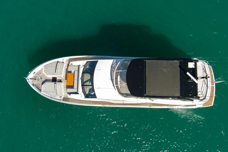 Slide: The Image of Overhead view of 2024 Sunseeker 76 Yacht on clear blue water. - 11