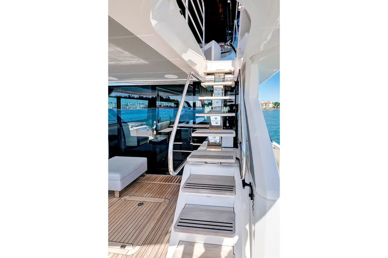 Slide: The Image of 2024 Sunseeker 76 Yacht interior with modern staircase and ocean view. - 16