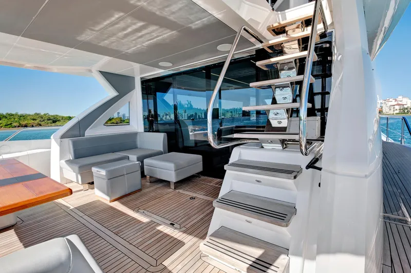Slide: The Image of Luxurious 2024 Sunseeker 76 Yacht deck with modern seating and sleek staircase. - 17
