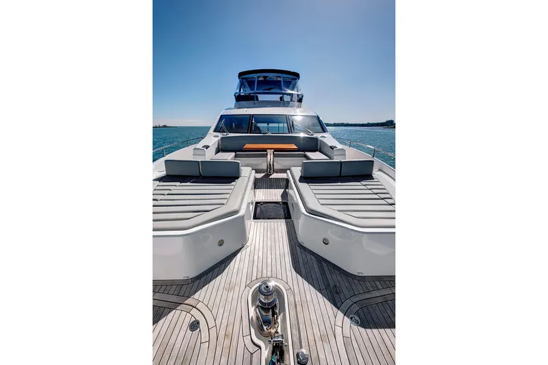 Slide: The Image of 2024 Sunseeker 76 Yacht with spacious deck and luxurious seating on open water. - 21