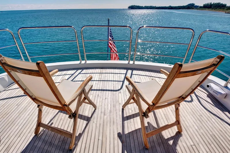 Slide: The Image of Deck view of 2024 Sunseeker 76 Yacht with chairs overlooking ocean. - 26