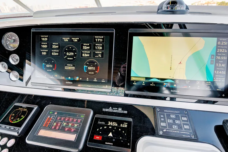 Slide: The Image of Control panel of 2024 Sunseeker 76 Yacht with navigation and engine displays. - 31