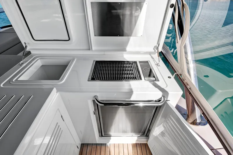 Slide: The Image of Outdoor kitchen on 2024 Sunseeker 76 Yacht with grill and sink, overlooking the sea. - 32