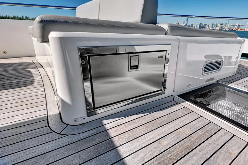 Slide: The Image of 2024 Sunseeker 76 Yacht deck with sleek seating and stainless steel storage. - 34