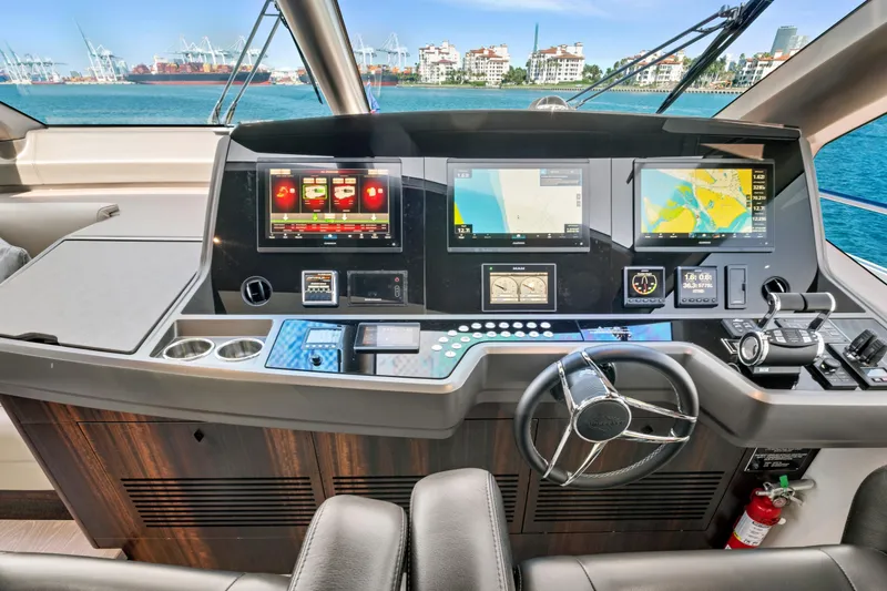 Slide: The Image of 2024 Sunseeker 76 Yacht helm with advanced navigation systems and ocean view. - 52