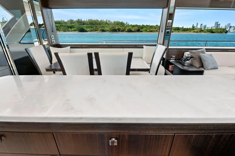 Slide: The Image of Luxurious interior of 2024 Sunseeker 76 Yacht with elegant seating and scenic ocean view. - 59