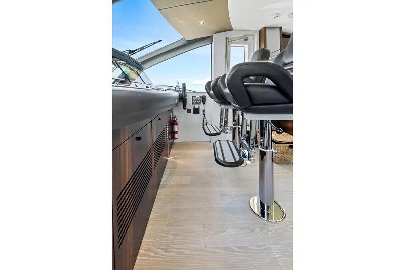 Slide: The Image of Interior of 2024 Sunseeker 76 Yacht, featuring sleek helm and modern seating. - 61