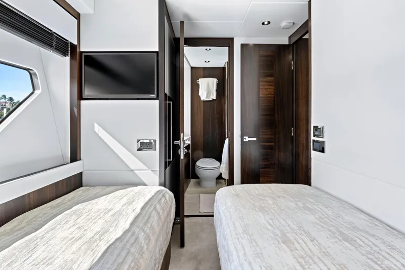 Slide: The Image of Luxurious interior of 2024 Sunseeker 76 Yacht with twin beds and ensuite bathroom. - 78