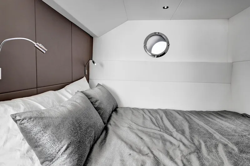 Slide: The Image of Luxurious bedroom interior of 2024 Sunseeker 76 Yacht with modern design and porthole window. - 96
