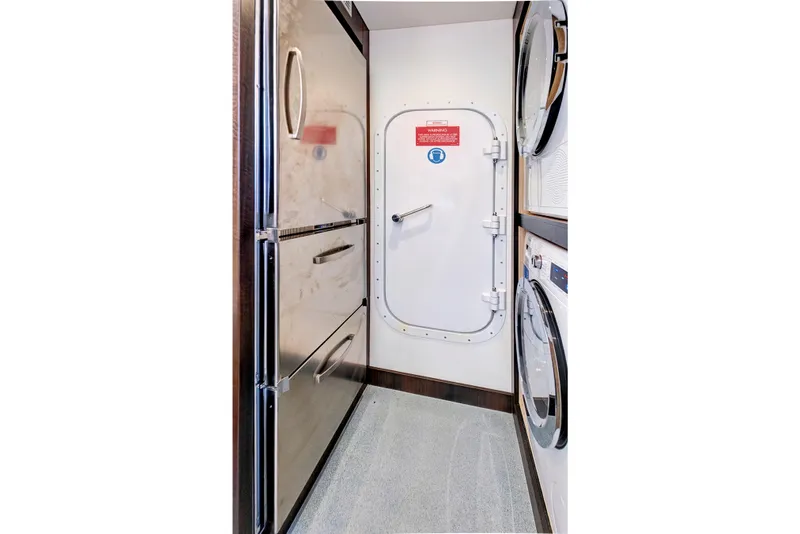 Slide: The Image of Interior of 2024 Sunseeker 76 Yacht with stainless steel appliances and secure door. - 99