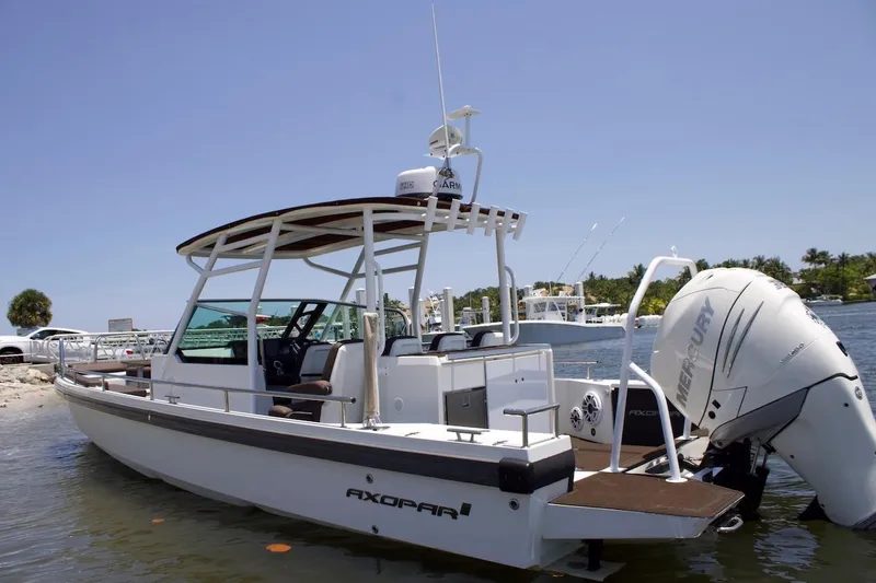 Slide: The Image of 2017 Axopar 28TT boat with Mercury engine docked by the shore. - 3