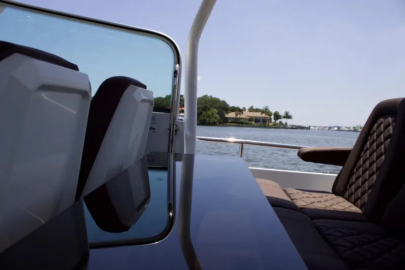 Slide: The Image of 2017 Axopar 28TT boat interior with luxurious seating and scenic water view. - 5