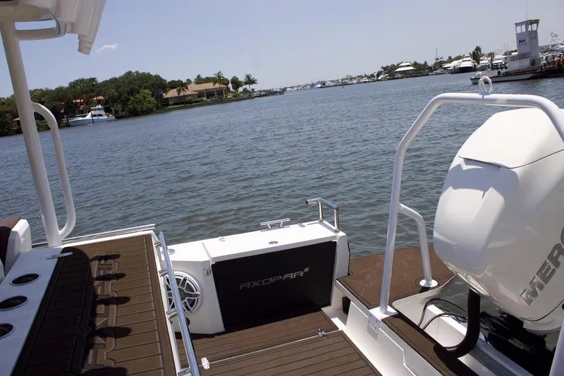 Slide: The Image of 2017 Axopar 28TT boat with Mercury engine on a calm waterway. - 7