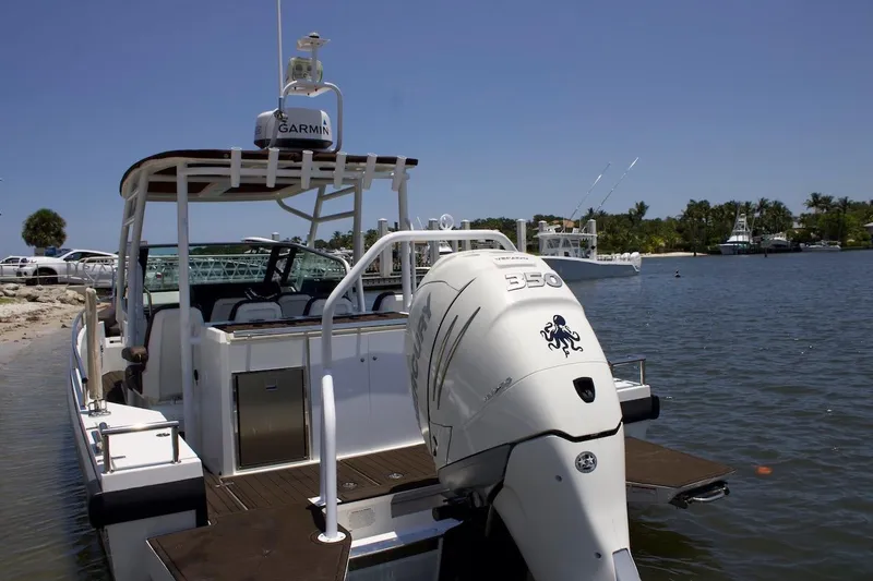 Slide: The Image of 2017 Axopar 28TT boat with Mercury 350 engine docked by the shore. - 8
