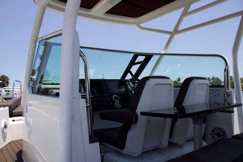 Slide: The Image of 2017 Axopar 28TT boat interior with dual seats and steering console. - 9