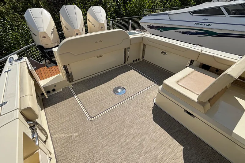 Slide: The Image of 2021 Chris-Craft Calypso 35 boat deck with Mercury engines, featuring spacious seating and elegant design. - 11