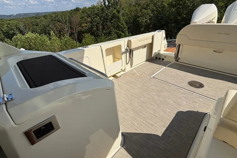 Slide: The Image of 2021 Chris-Craft Calypso 35 boat deck with seating and scenic forest view. - 12