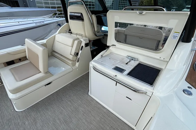 Slide: The Image of 2021 Chris-Craft Calypso 35 interior with seating and kitchenette area. - 16