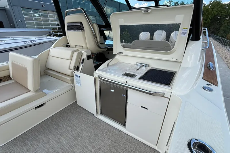 Slide: The Image of 2021 Chris-Craft Calypso 35 boat interior with seating and kitchenette area. - 17