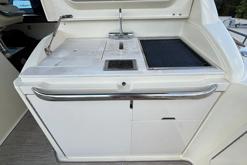 Slide: The Image of Outdoor kitchen on 2021 Chris-Craft Calypso 35 boat with sink and grill. - 20