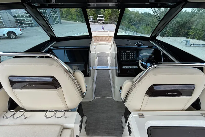 Slide: The Image of 2021 Chris-Craft Calypso 35 boat interior with dual helm seats and modern dashboard. - 28