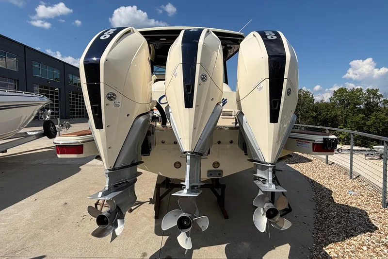 Slide: The Image of 2021 Chris-Craft Calypso 35 with triple outboard engines, docked outdoors. - 3