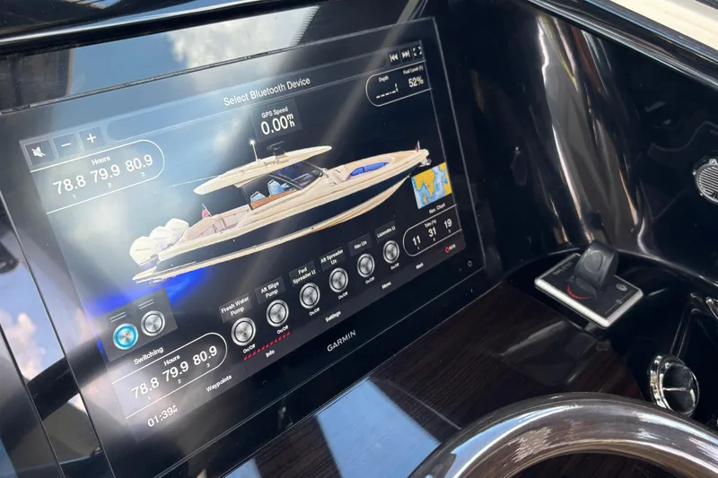 Slide: The Image of 2021 Chris-Craft Calypso 35 dashboard with Garmin display and controls. - 34