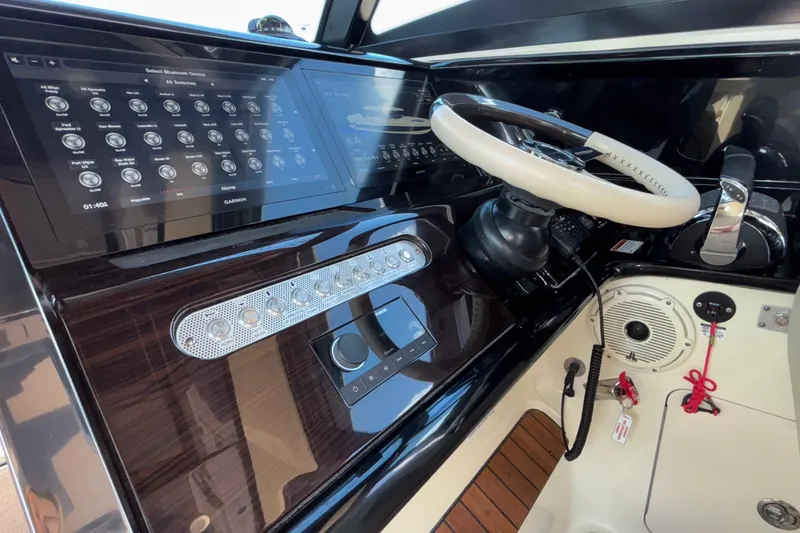 Slide: The Image of 2021 Chris-Craft Calypso 35 helm with modern controls and touchscreen display. - 35