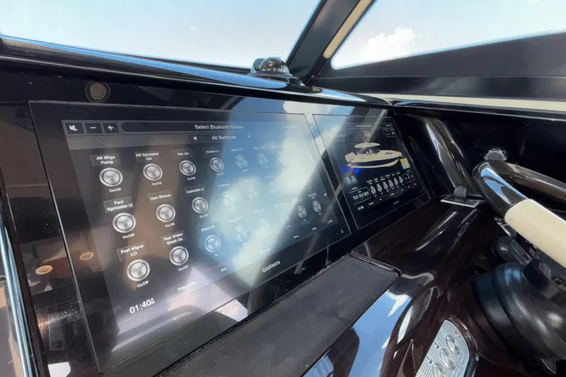 Slide: The Image of 2021 Chris-Craft Calypso 35 dashboard with advanced touchscreen controls and steering wheel. - 36