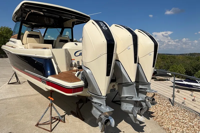 Slide: The Image of 2021 Chris-Craft Calypso 35 boat with triple outboard engines on a sunny day. - 4