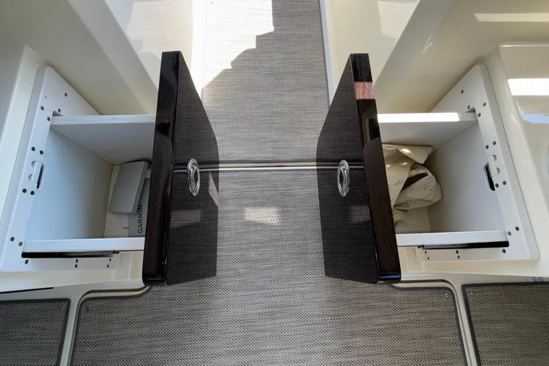 Slide: The Image of 2021 Chris-Craft Calypso 35 storage compartments with open doors and visible interior. - 47