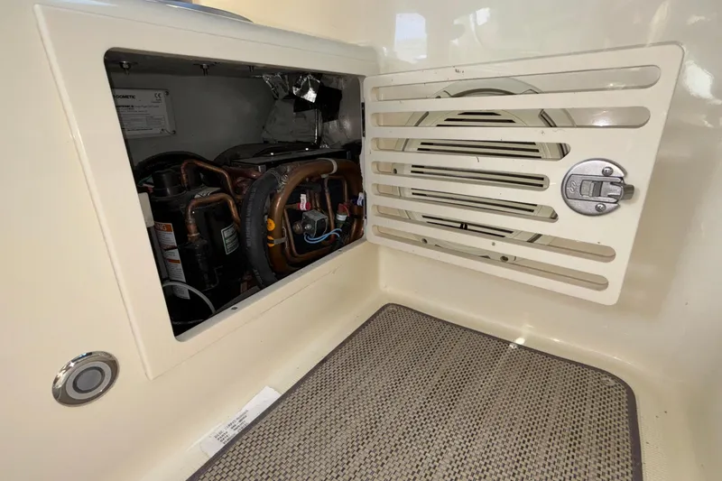 Slide: The Image of 2021 Chris-Craft Calypso 35 interior compartment with visible mechanical components. - 48