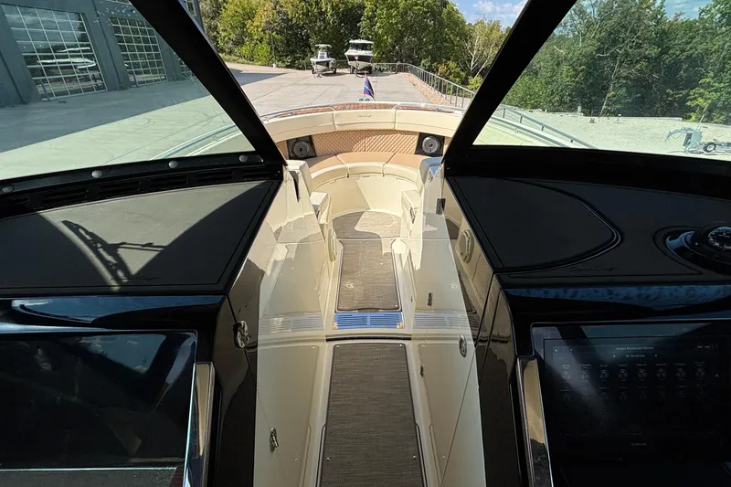 Slide: The Image of Interior view of 2021 Chris-Craft Calypso 35 boat, showcasing helm and seating area. - 52